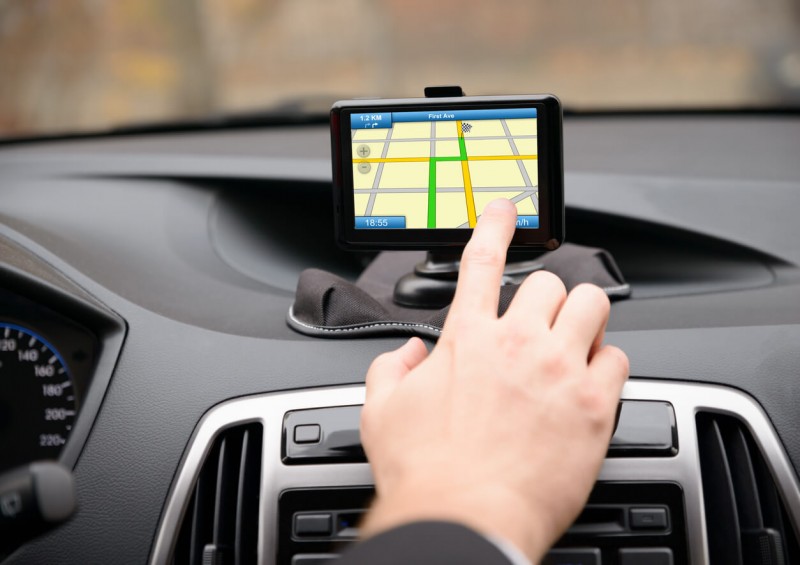 Person setting up Sat Nav in their car