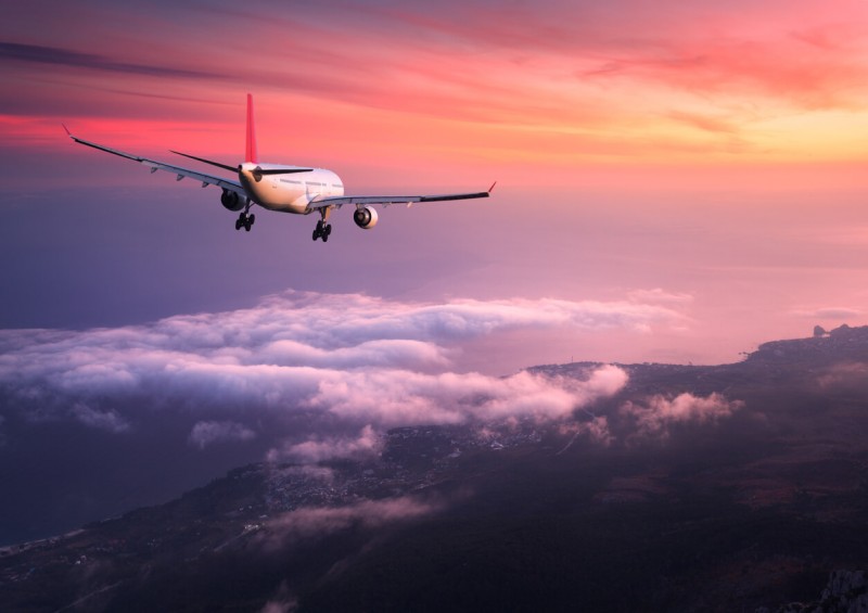 plane flying in the sunset