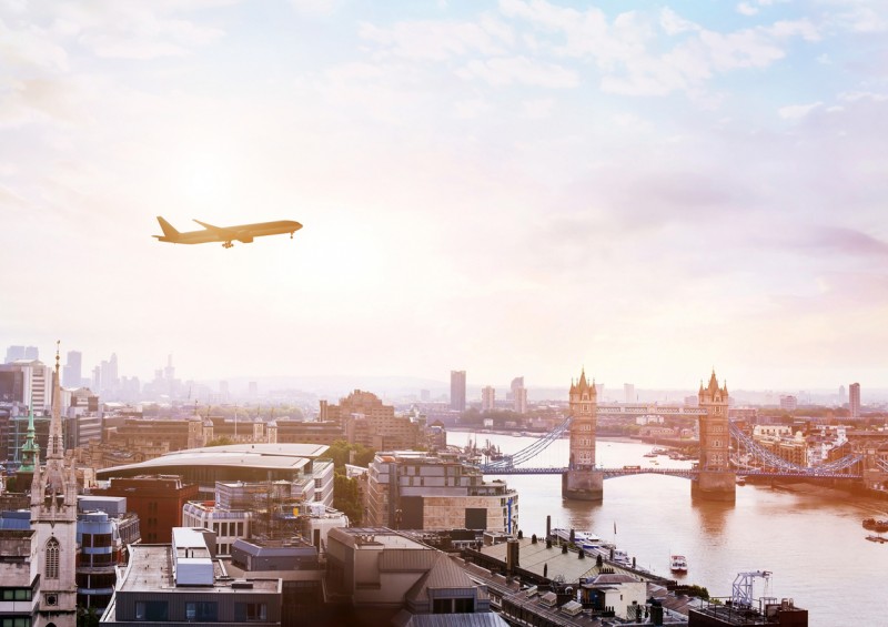 plane flying over tower bridge in london