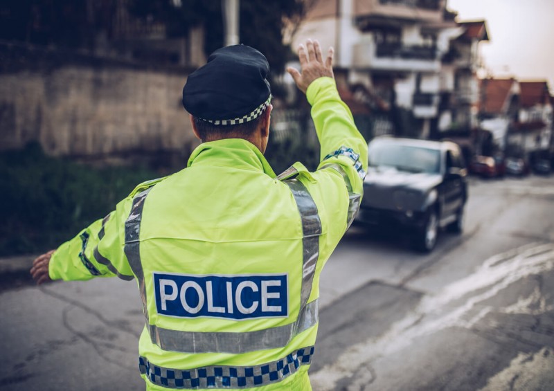 police officer pulling over car on uk road