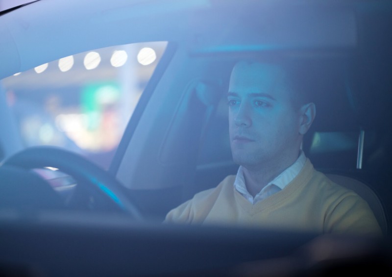 Smart casual man driving a vehicle