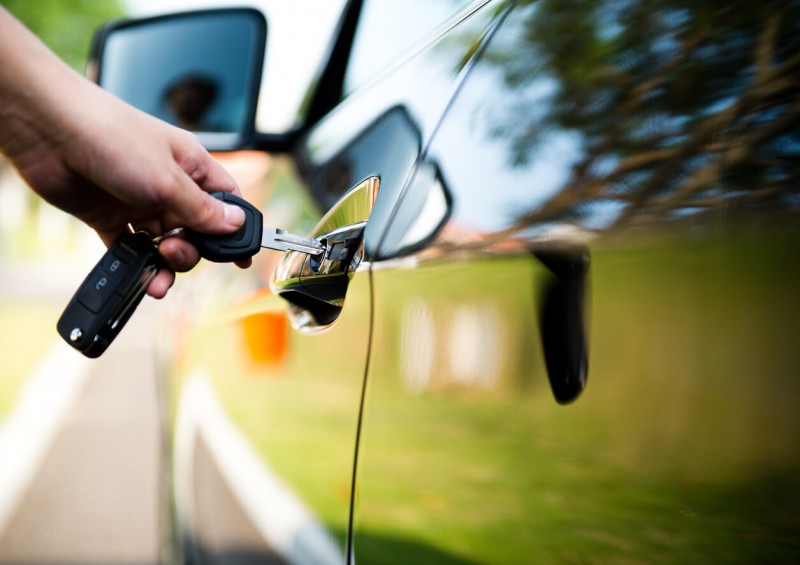 Someone putting key in car door