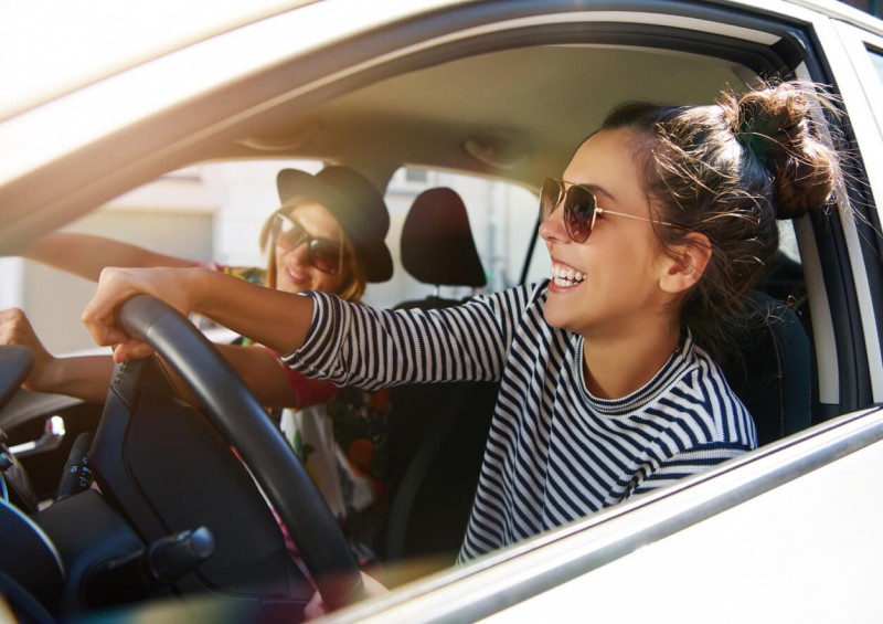 Student driving a car with friend