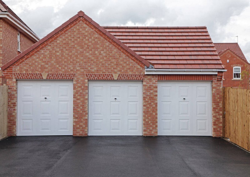 Three garages next to each other with doors closed