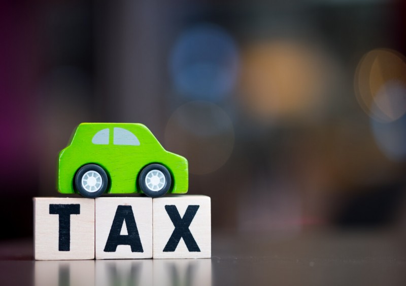 Toy car on top of tax letter blocks