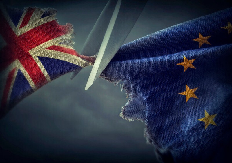 UK flag and EU flag being cut apart