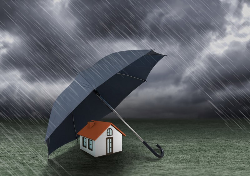 Umbrella protecting house from the rain