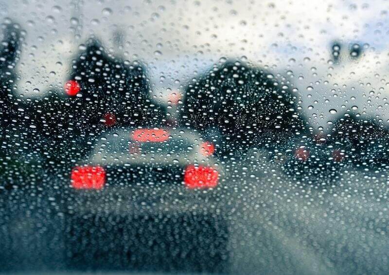 View out of a rainy car windscreen in traffic