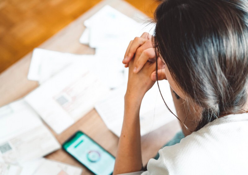 Woman distressed looking at credit score
