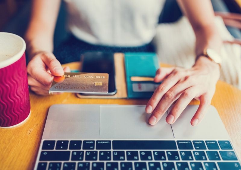 Woman online shopping for cashback