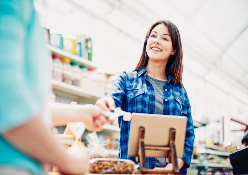 Woman paying for shopping using her loyalty card