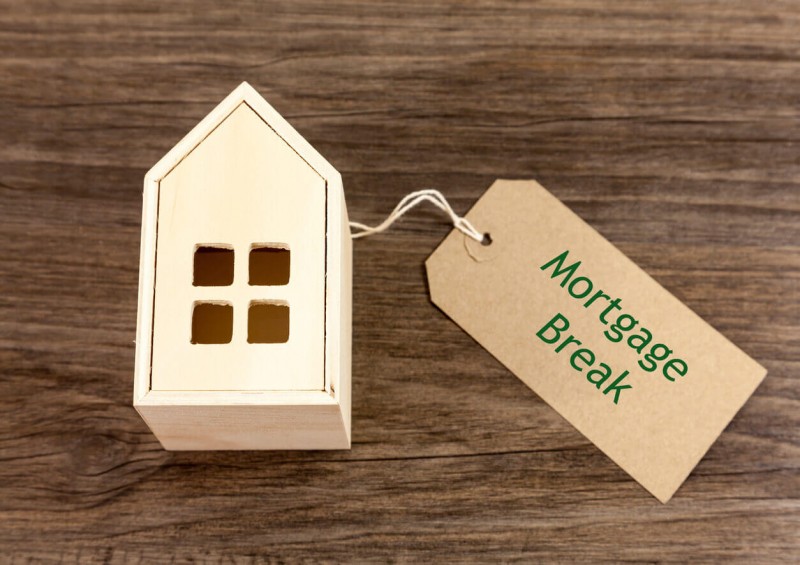 Wooden house with price tag stating Mortgage Break