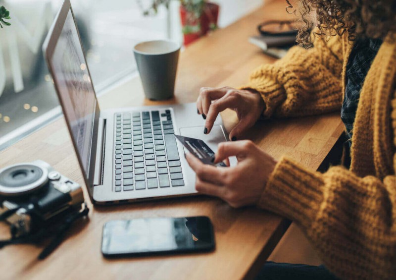 Young adult sorting out finances on laptop