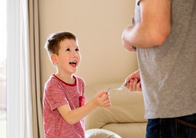 young boy recieving money from parent