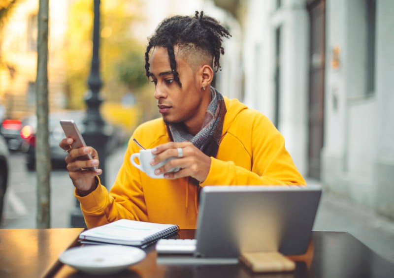 Young man at cafe on Bo mobile bank