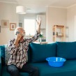 A man on the phone while looking at a leak at home