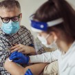 A middle aged man having the covid 19 vaccine