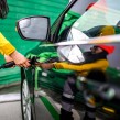 A woman charging her electric car