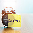 Clock with tax time post it note