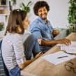 Couple smiling checking their debt letters