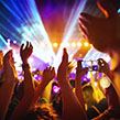 Hands in the air dancing by festival stage at night