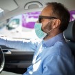 Man driving car with Covid face mask