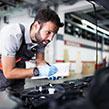 Man MOT testing a car at a garage