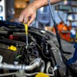 Mechanic checking oil during MOT