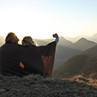 Older couple having a selfie at the top of a mountain