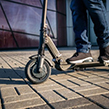 Person riding electric scooter on street