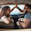 Two people looking very happy in their car