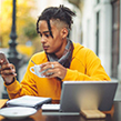 Young man at cafe on Bo mobile bank